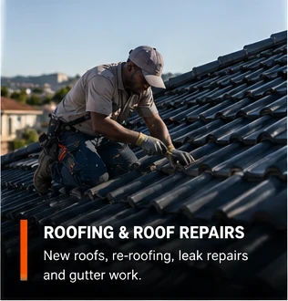 Roofer in a safety harness working on a tiled roof