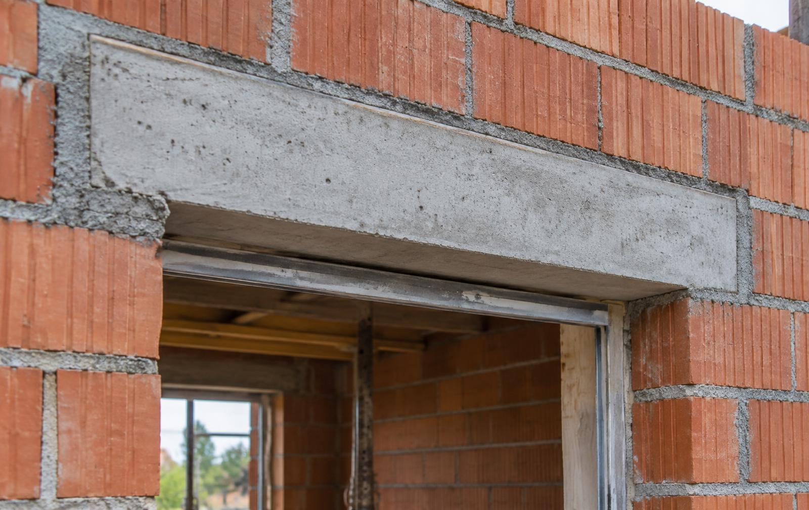 Concrete lintel installed above a door opening in a brick wall